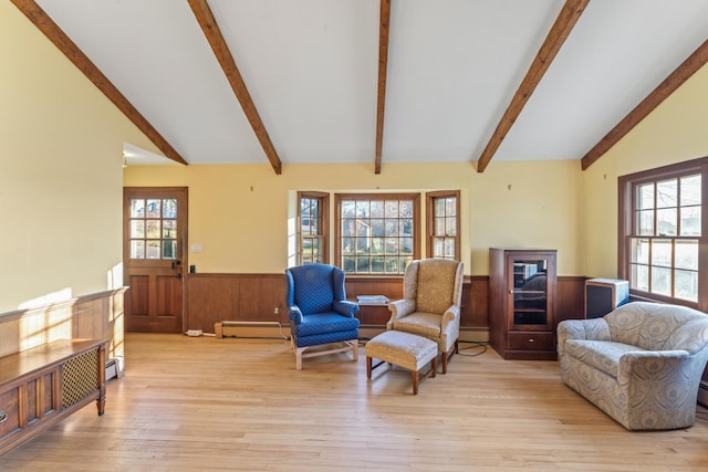 living room featuring vaulted ceiling with beams, a healthy amount of sunlight, light hardwood / wood-style floors, and a baseboard radiator