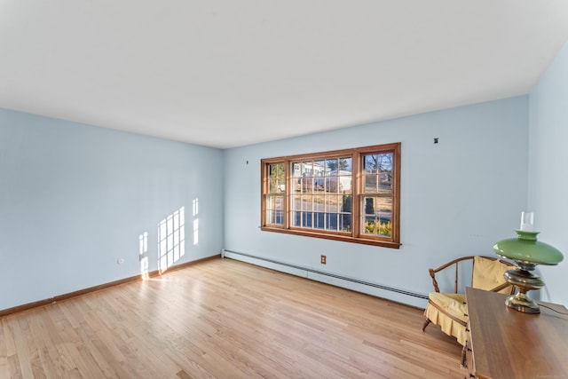 interior space featuring light wood-type flooring and a baseboard heating unit