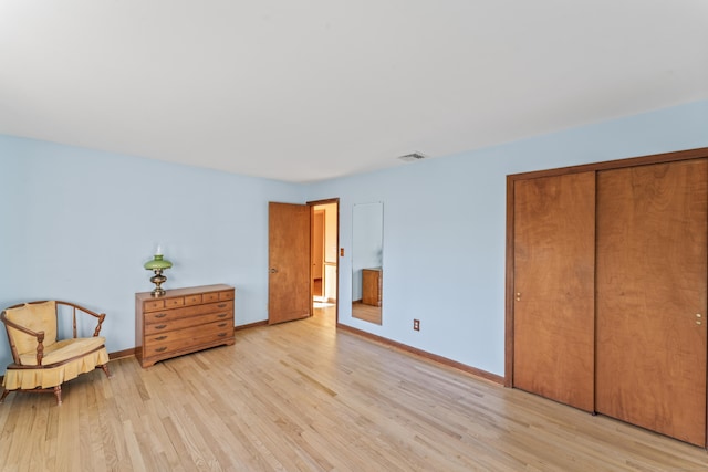 bedroom featuring light wood-type flooring and a closet