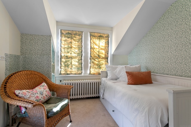 bedroom featuring light colored carpet and radiator