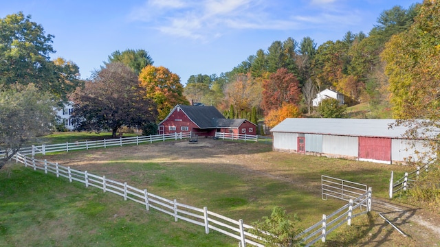 view of yard featuring a rural view and an outdoor structure