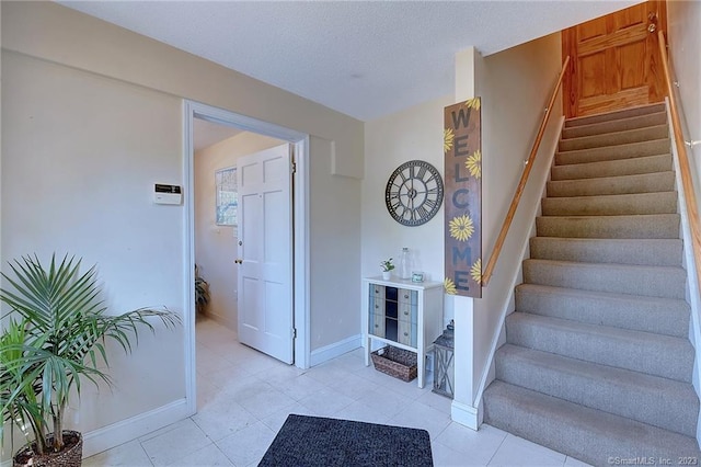 foyer entrance featuring light tile patterned flooring