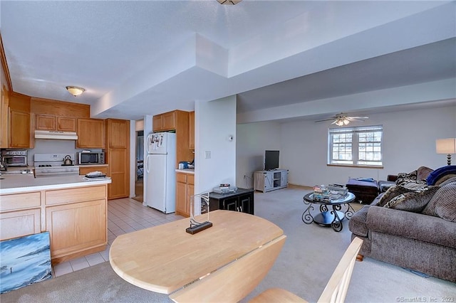 kitchen featuring ceiling fan, light tile patterned floors, and white appliances