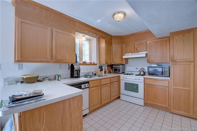 kitchen with light brown cabinets, sink, light tile patterned floors, a textured ceiling, and white appliances