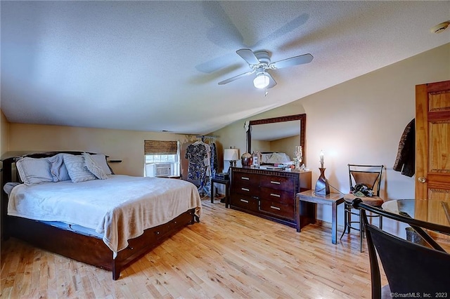 bedroom with vaulted ceiling, light hardwood / wood-style flooring, and ceiling fan