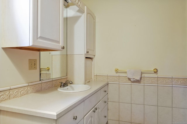 bathroom featuring vanity and tile walls