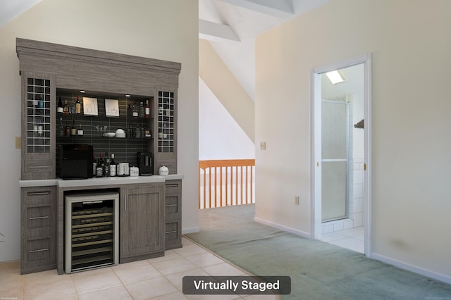 bar featuring wine cooler, lofted ceiling with beams, and light colored carpet