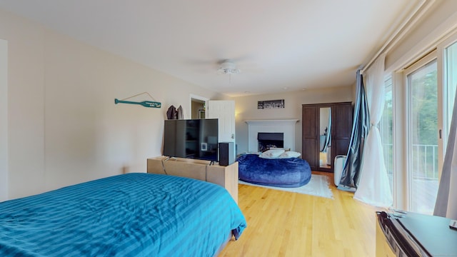 bedroom with a fireplace and wood finished floors