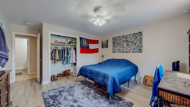 bedroom featuring a closet, light wood-style flooring, and baseboards