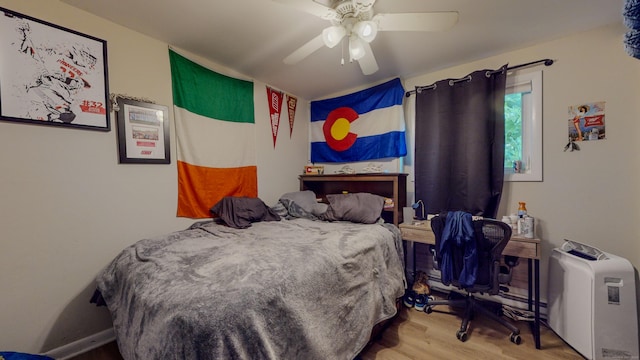 bedroom featuring wood finished floors and a ceiling fan