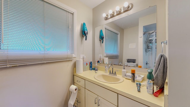 full bath with a shower and vanity