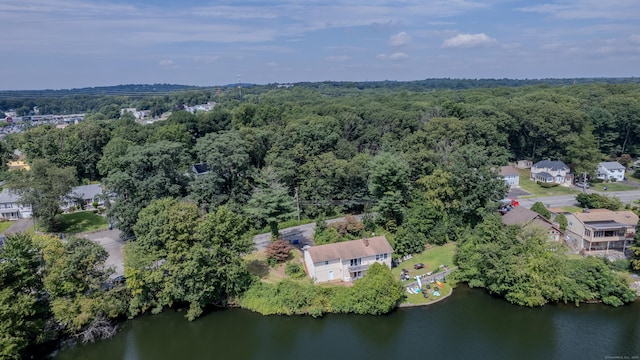 birds eye view of property featuring a water view and a view of trees