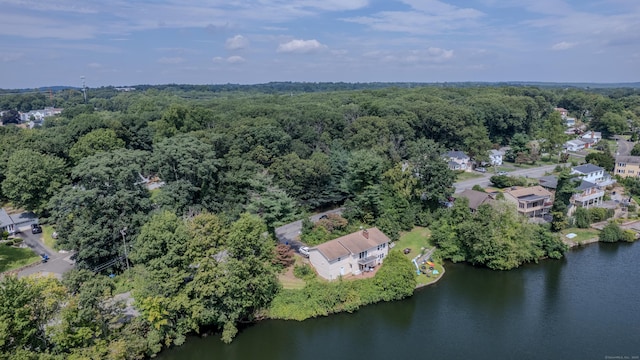 drone / aerial view with a water view and a wooded view