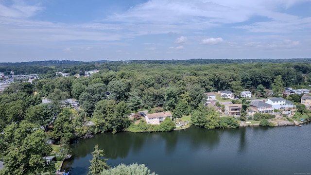 drone / aerial view with a water view and a forest view