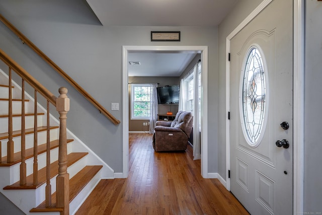 entryway with plenty of natural light and hardwood / wood-style flooring