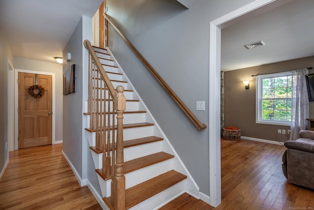 stairway featuring hardwood / wood-style floors