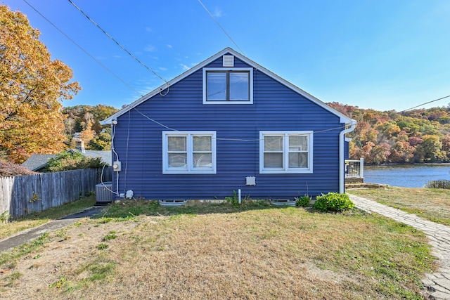 view of side of property featuring a yard and a water view