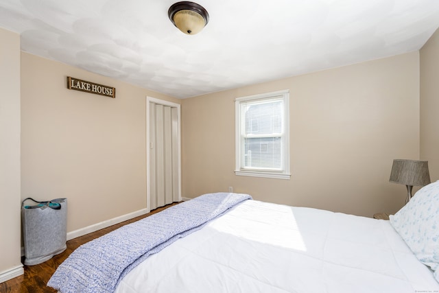 bedroom with dark wood-type flooring