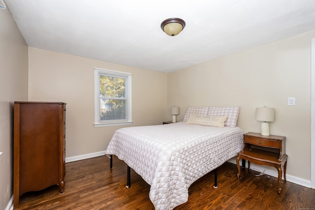 bedroom with dark hardwood / wood-style flooring