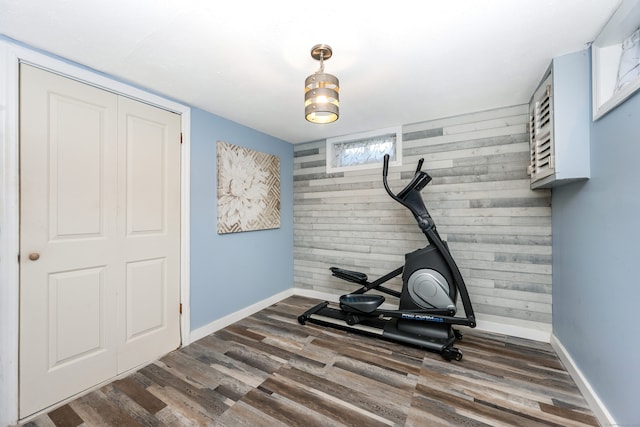 exercise room with dark hardwood / wood-style floors