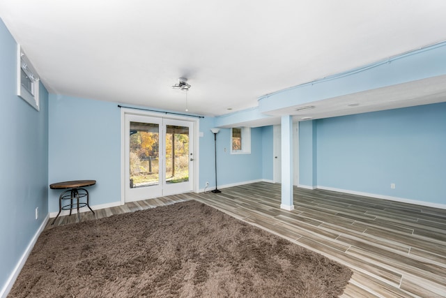 basement with hardwood / wood-style floors