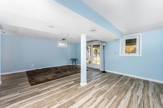 basement with light hardwood / wood-style floors