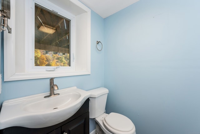 bathroom featuring vanity and toilet