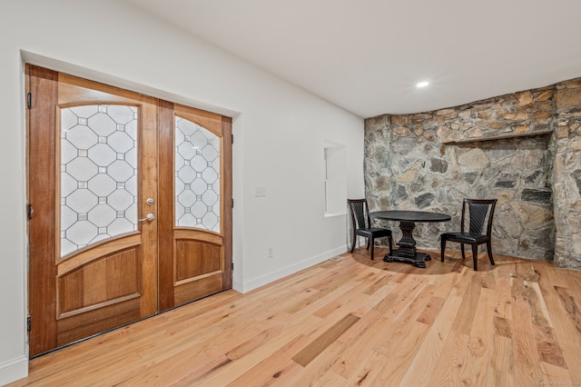 foyer featuring hardwood / wood-style flooring and french doors