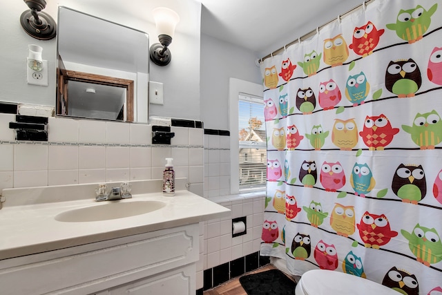 bathroom featuring vanity, toilet, tile walls, and a shower with shower curtain