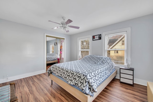 bedroom with a closet, ceiling fan, and hardwood / wood-style flooring