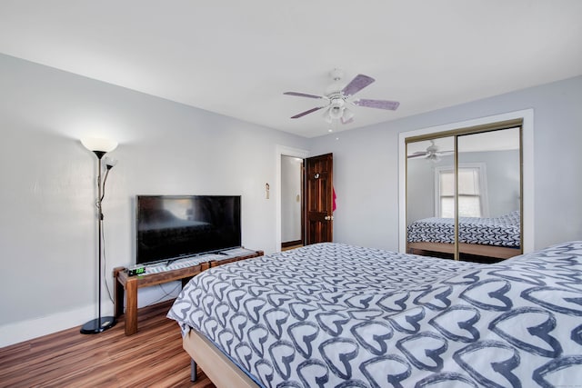 bedroom with a closet, hardwood / wood-style floors, and ceiling fan