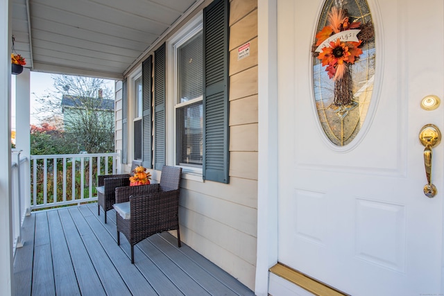 wooden terrace featuring covered porch