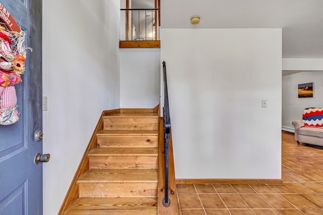 stairway featuring tile patterned flooring