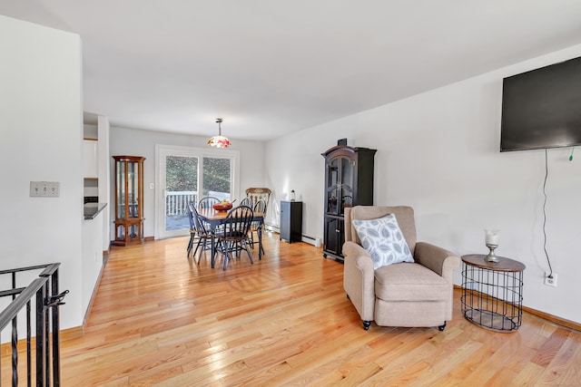 interior space with a baseboard radiator and light hardwood / wood-style flooring