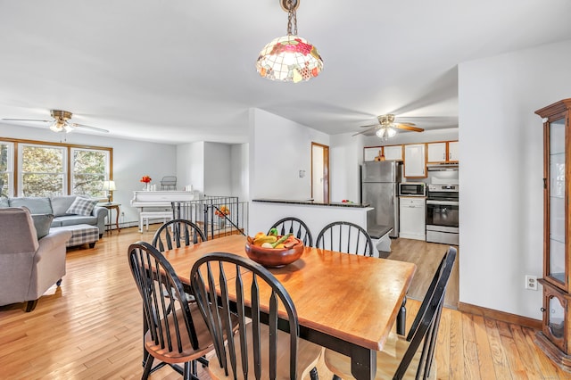 dining space featuring light hardwood / wood-style floors and ceiling fan