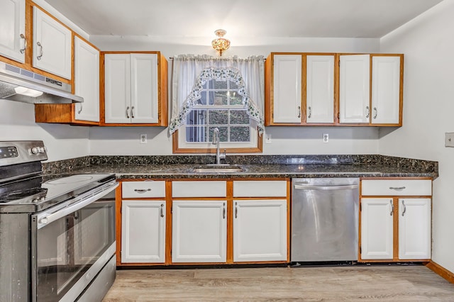 kitchen with sink, appliances with stainless steel finishes, light wood-type flooring, and white cabinets