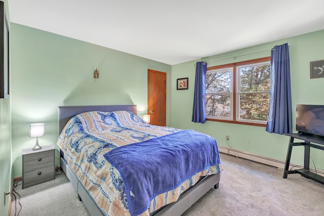 carpeted bedroom featuring a baseboard heating unit