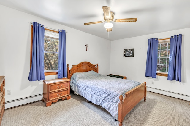 bedroom with light carpet, a baseboard radiator, and ceiling fan