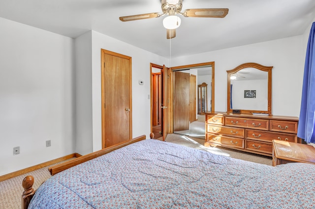 carpeted bedroom featuring a closet and ceiling fan