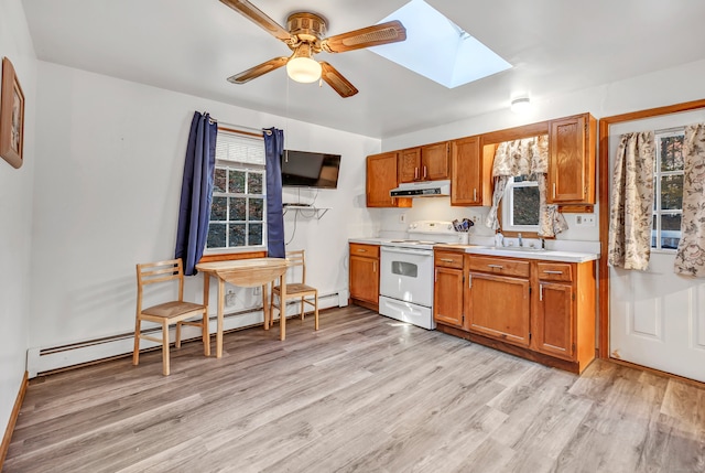 kitchen featuring a skylight, ceiling fan, baseboard heating, white electric range, and light hardwood / wood-style flooring