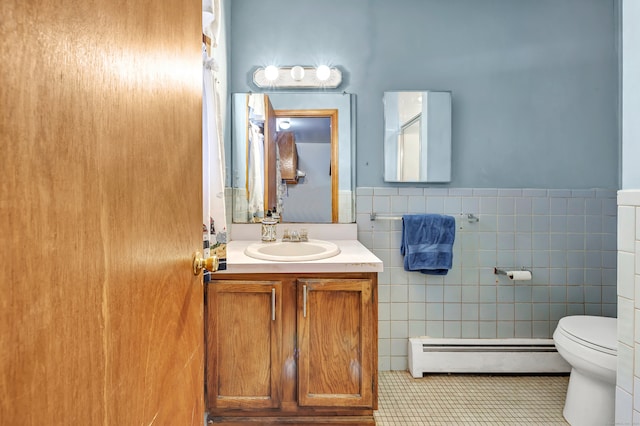 bathroom featuring a baseboard radiator, tile walls, toilet, vanity, and tile patterned floors