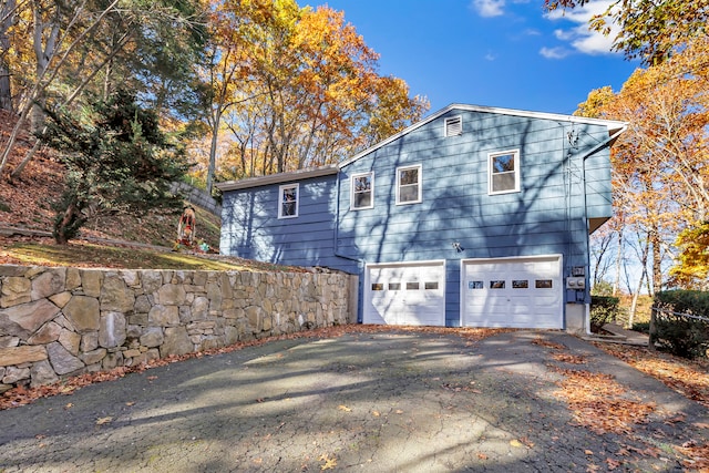 view of side of property with a garage