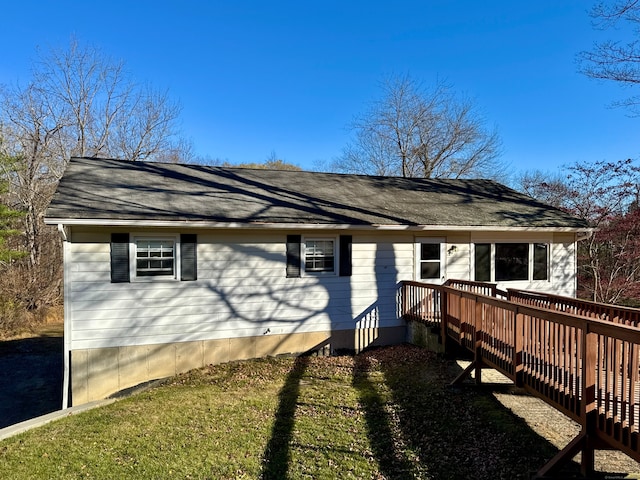 view of front of house with a front lawn and a wooden deck