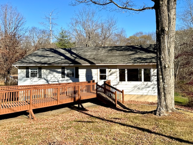 back of house with a yard and a wooden deck