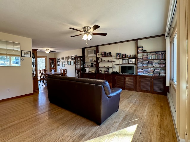 living room featuring hardwood / wood-style floors, ceiling fan, and a textured ceiling