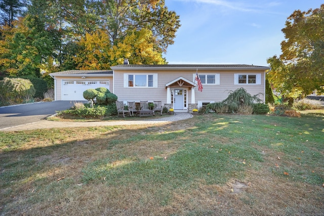 split foyer home with a front yard and a garage