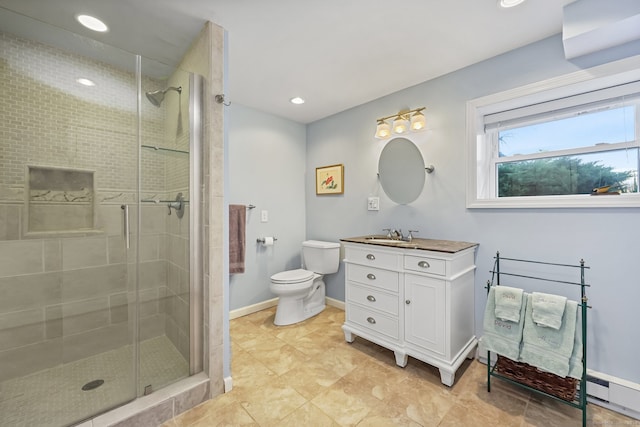 bathroom with vanity, toilet, walk in shower, and a baseboard heating unit