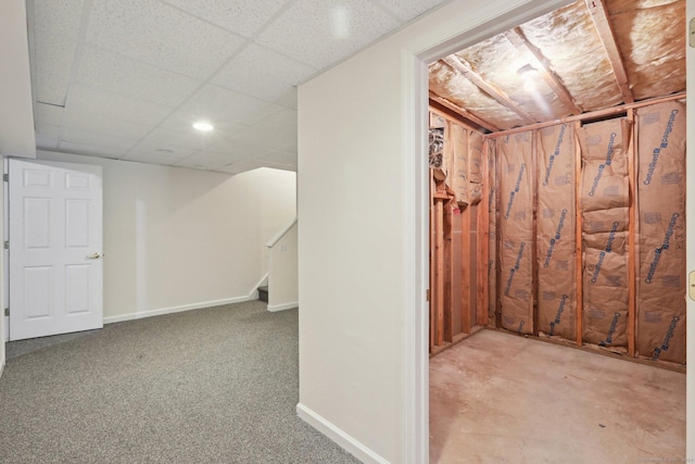 basement with light carpet and a paneled ceiling