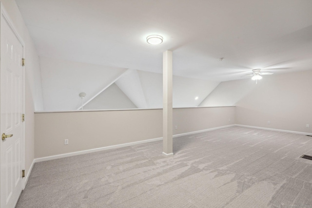 additional living space featuring lofted ceiling and carpet