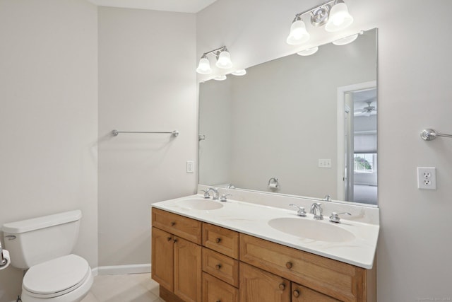 bathroom with vanity, tile patterned floors, and toilet